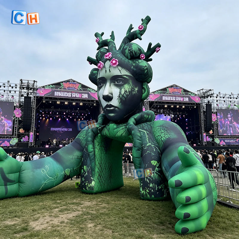 Green dryad tree goddess inflatable arch decoration at outdoor music festival stage