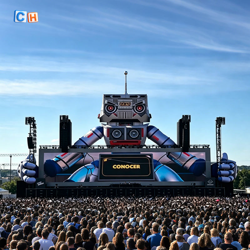 Giant inflatable robot stage decor with crowd at outdoor music festival concert